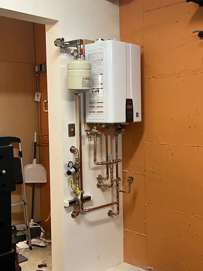 Plumbing technician inspecting water heater connections in Santa Clara